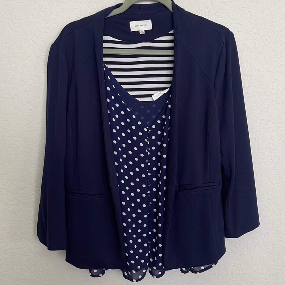 Skies are a blue Navy Blazer